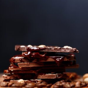 chocolate and nuts over black background.