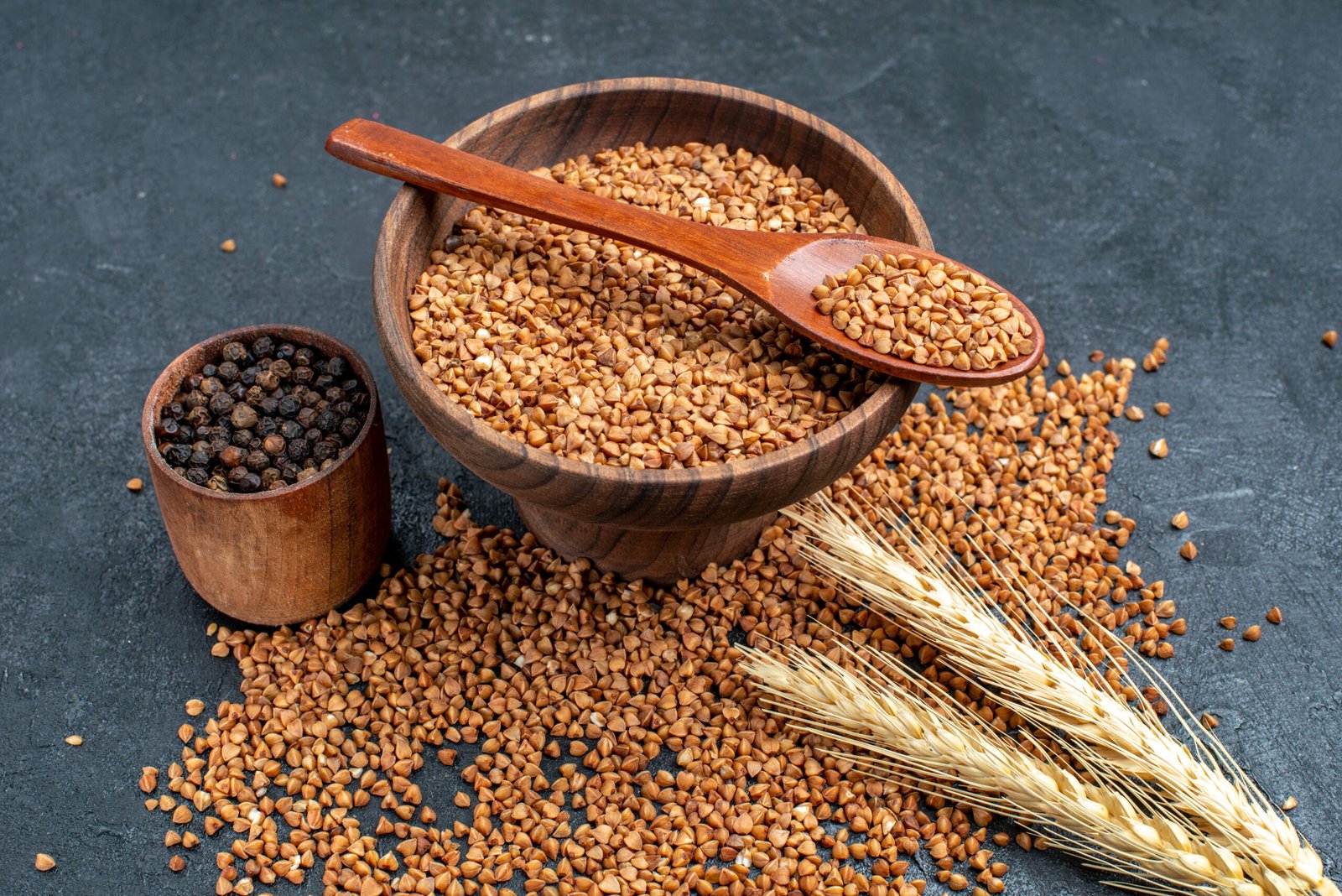 front view raw buckwheat fresh ingredients inside brown plate grey space