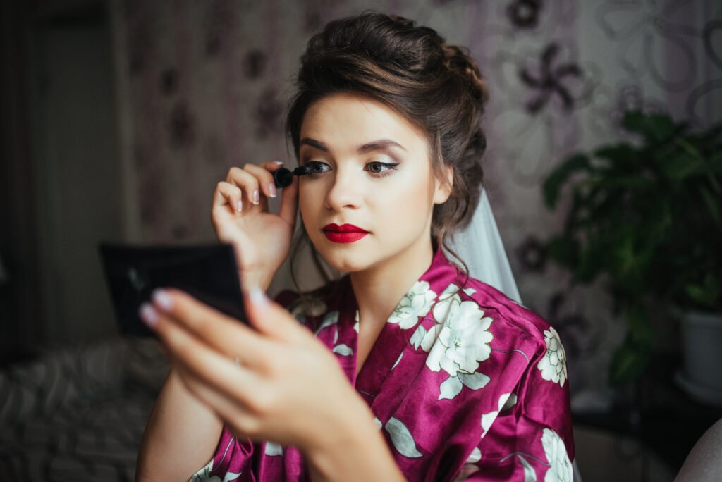 wedding preparations. portrait of beautiful happy bride with wedding makeup and wedding hairstyle. gorgeous young bride at home in the morning. bride make beautiful makeup