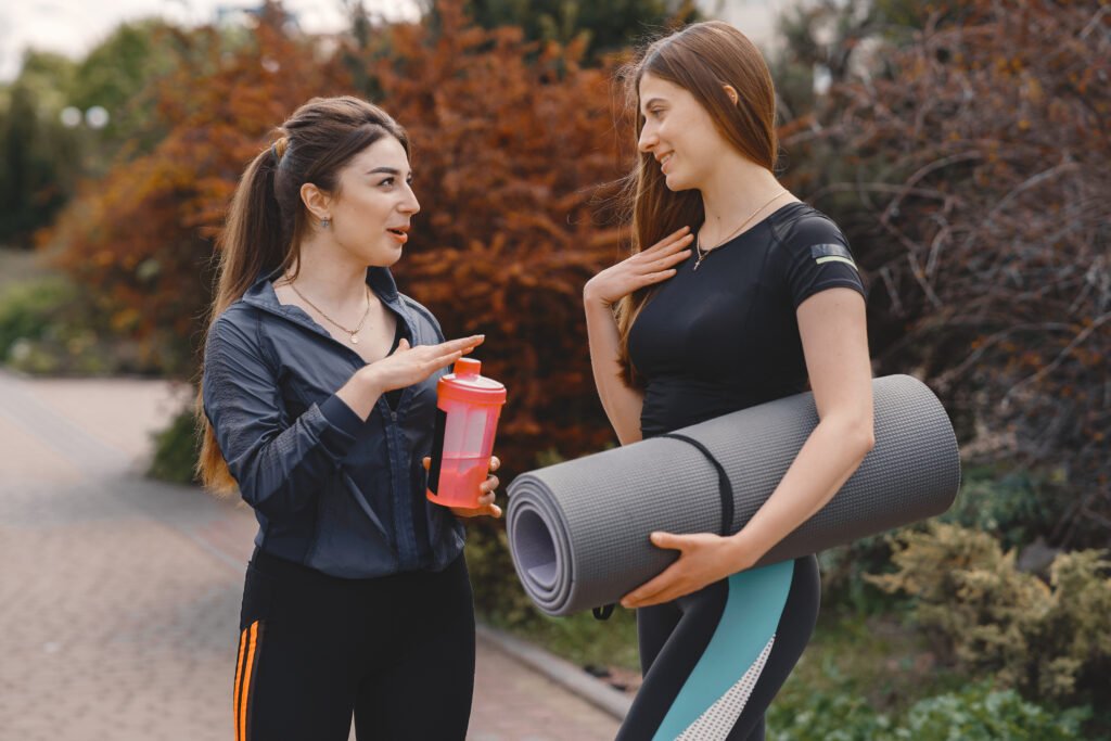 sports girls training in a summer forest