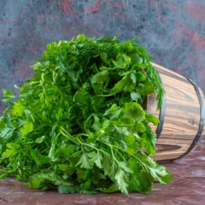 various greens in a bucket , on the marble background