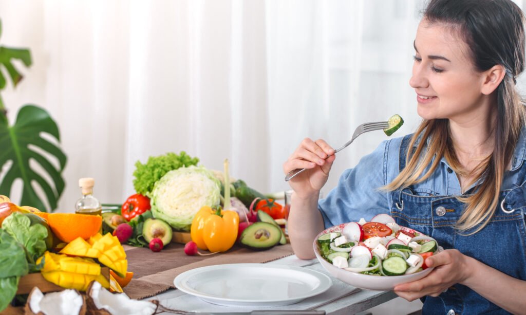 Healthy Diet & Nutrition young and happy woman eating salad at the table